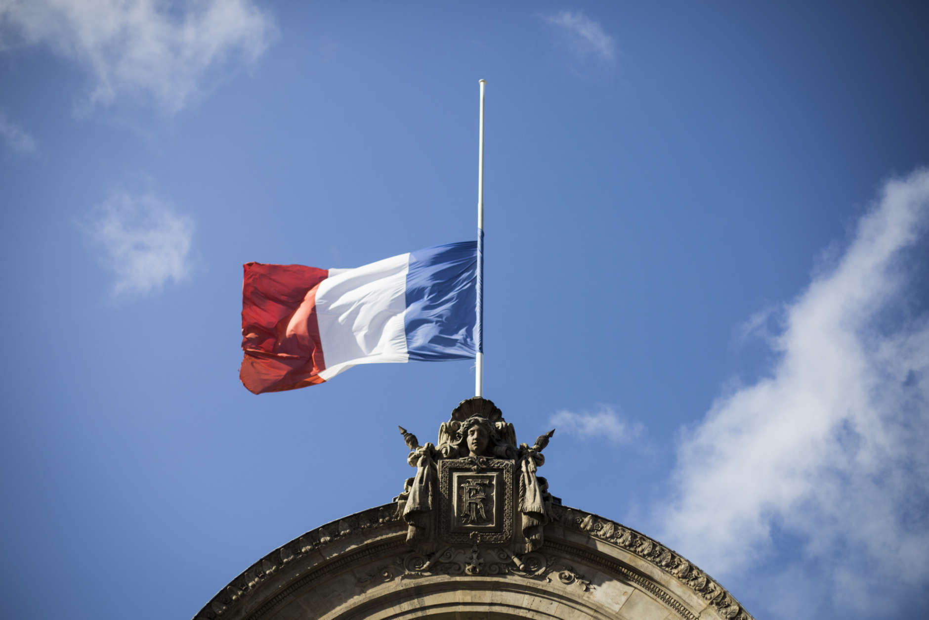 A French flag flies at half-staff for the victims of the Spain attacks, on the Elysee Palace, in Paris, Saturday, Aug. 19, 2017. Police on Friday shot and killed five people carrying bomb belts who were connected to the Barcelona van attack, as the manhunt intensified for the perpetrators of Europe's latest rampage claimed by the Islamic State group. (AP Photo/Kamil Zihnioglu)