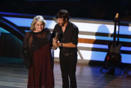 Susan Nadler accepts the Poet's Award on behalf of Shel Silverstein from artist Chris Janson during the 11th annual ACM Honors at the Ryman Auditorium on Wednesday, Aug. 23, 2017, in Nashville, Tenn. (Photo by Wade Payne/Invision/AP)