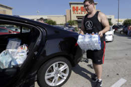 William Hazzard loads water into his car in preparation for tropical weather on Thursday, Aug. 24, 2017, in Houston. Tropical Storm Harvey is expected to intensify over the warm waters of the Gulf of Mexico before reaching the Texas coast Friday. (AP Photo/David J. Phillip)