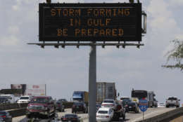 Motorists in Houston pass a sign warning of Hurricane Harvey as the storm intensifies in the Gulf of Mexico, Thursday, Aug. 24, 2017. Harvey is forecast to be a major hurricane when it makes landfall along the middle Texas coastline Friday. (AP Photo/David J. Phillip)