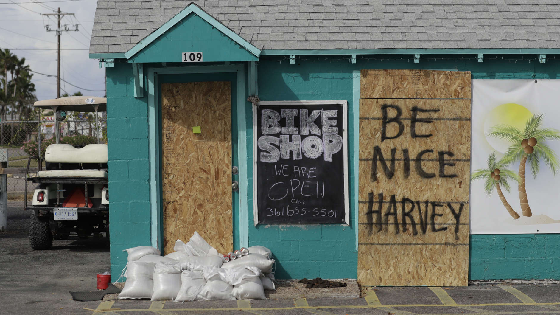 A sign reading "Be Nice Harvey" was left behind on a boarded up business, Thursday, Aug. 24, 2017, in Port Aransas, Texas. Port Aransas is under a mandatory evacuation for Hurricane Harvey. (AP Photo/Eric Gay)