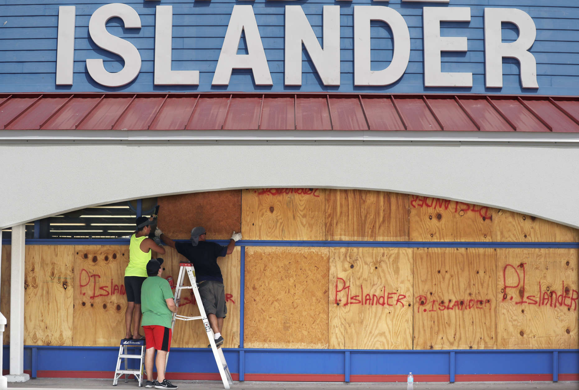 Workers cover a business with plywood in preparation for Hurricane Harvey, Thursday, Aug. 24, 2017, in Corpus Christi, Texas. (AP Photo/Eric Gay)