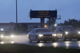 Motorists pass a warning sign as Hurricane Harvey approaches the Gulf Coast area Friday, Aug. 25, 2017, in Corpus Christi, Texas.  The slow-moving hurricane could be the fiercest such storm to hit the United States in almost a dozen years. Forecasters labeled Harvey a "life-threatening storm" that posed a "grave risk" as millions of people braced for a prolonged battering. (AP Photo/Eric Gay)