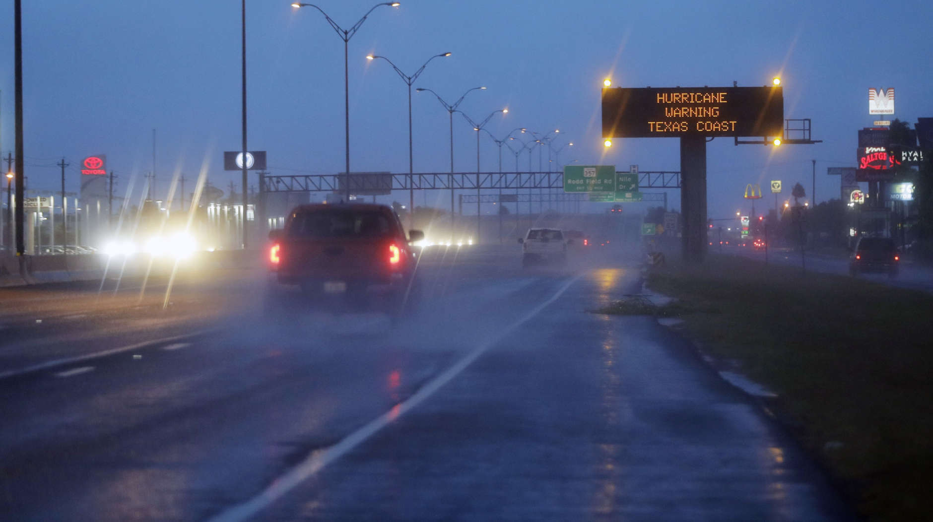 Motorists pass a warning sign  as Hurricane Harvey approaches the Gulf Coast area Friday, Aug. 25, 2017, in Corpus Christi, Texas.  The slow-moving hurricane could be the fiercest such storm to hit the United States in almost a dozen years. Forecasters labeled Harvey a "life-threatening storm" that posed a "grave risk" as millions of people braced for a prolonged battering. (AP Photo/Eric Gay)
