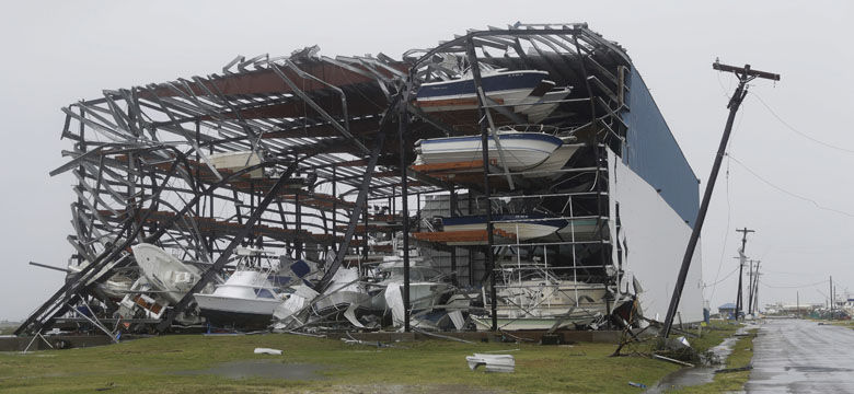 Toppled boats hang in the debris of a boat storage facility that was damaged by Hurricane Harvey, Saturday, Aug. 26, 2017, in Rockport, Texas. (AP Photo/Eric Gay)