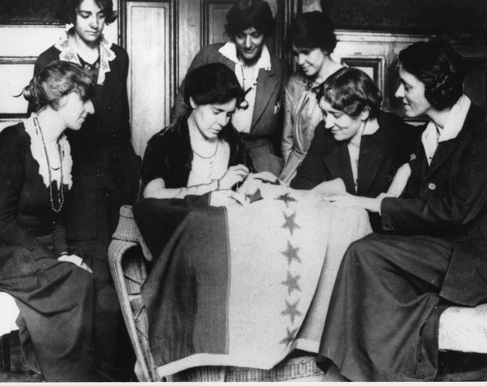 Celebrating ratification of the women's suffrage amendment, Alice Paul, seated second from left, sews the 36th star on a banner, in August of 1920.  The banner flew in front of headquarters of the Women's Party in Washington of which Miss Paul was national chairperson.  The 36th star represented Tennessee, whose ratification completed the number of states needed to put the amendment in the Constitution.  (AP Photo)