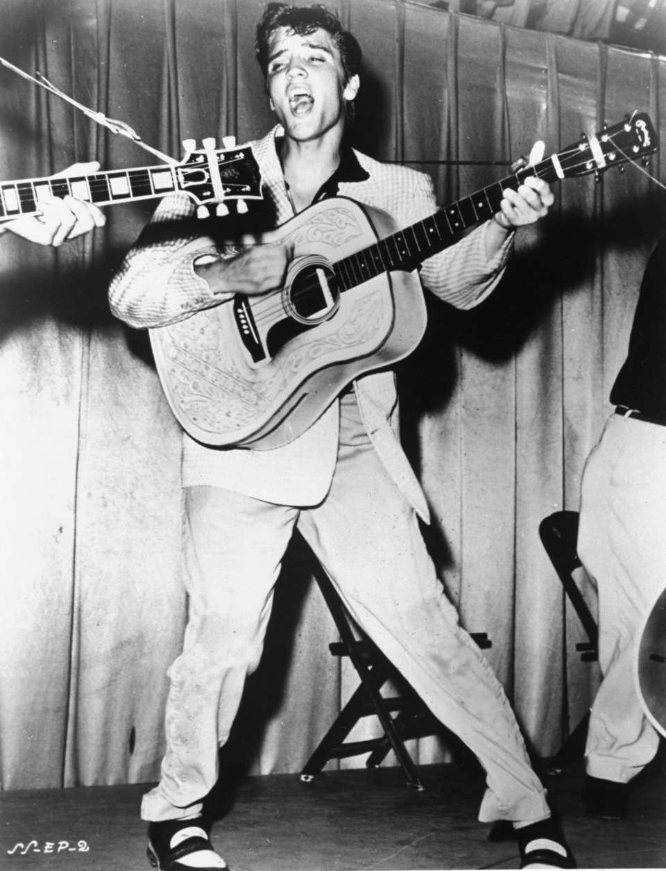 This is a 1956 photo of Elvis Presley performing.  This photo was used for his first RCA Victor album cover. (AP Photo)