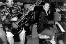 Piano virtuoso Liberace is shown playing the guitar with Elvis Presley at the piano in November 1956 at the Riviera Hotel in Las Vegas.  (AP Photo)
