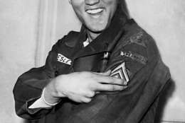 American rock and roll singer Elvis Presley smiles after he is promoted to army sergeant at the U.S. Army Unit's maneuver headquarters in Grafenwoehr, Germany, Feb. 11, 1960.  Presley is promoted to the NCO rank in the 1st Battalion, 32d Armor Regiment, 3d Armored Division.  (AP Photo)