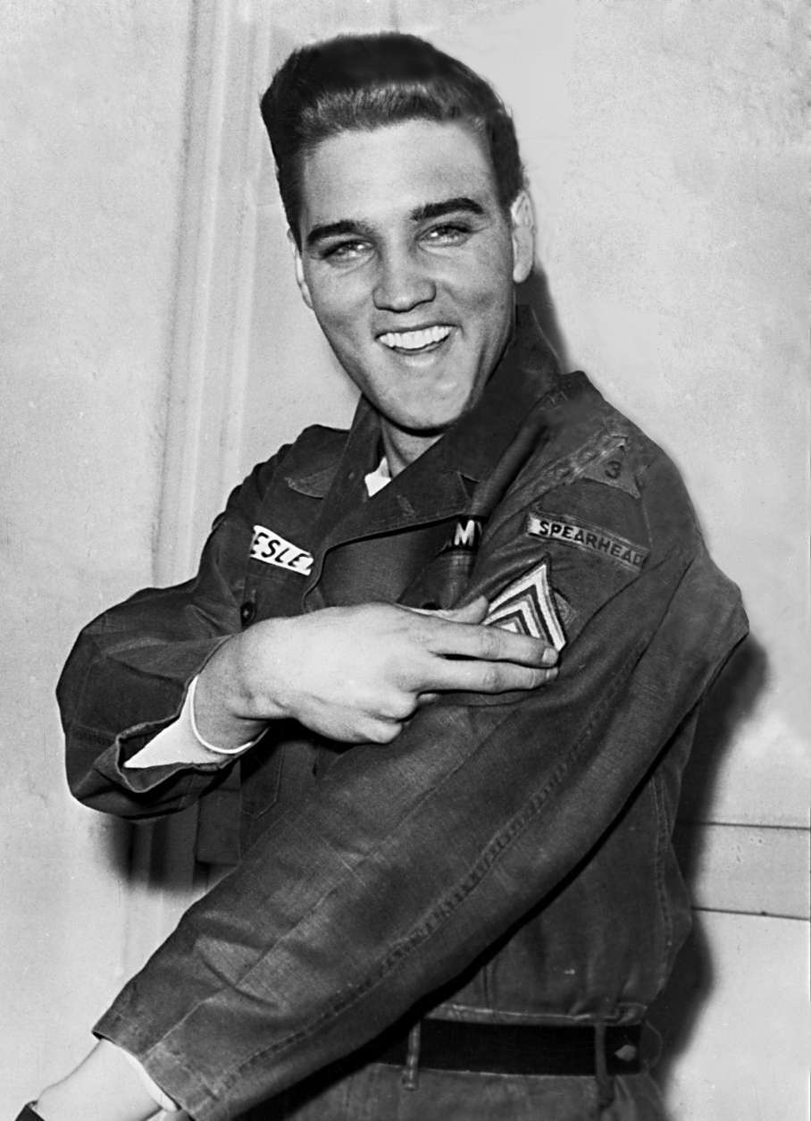 American rock and roll singer Elvis Presley smiles after he is promoted to army sergeant at the U.S. Army Unit's maneuver headquarters in Grafenwoehr, Germany, Feb. 11, 1960.  Presley is promoted to the NCO rank in the 1st Battalion, 32d Armor Regiment, 3d Armored Division.  (AP Photo)