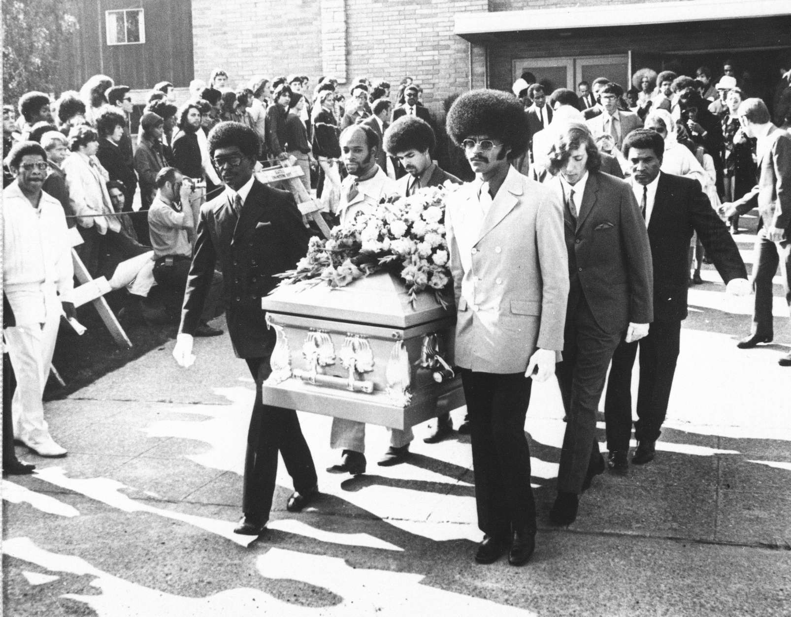 Friends of the late rock star Jimi Hendrix carry his coffin from the church after funeral services, Oct. 1, 1970 in Seattle.  Pallbearers include Herbert Price, left, Hendrix' valet; Donny Howell behind Price; and Eddie Rye, front right.  Others are unidentified.  (AP Photo/Barry Sweet)