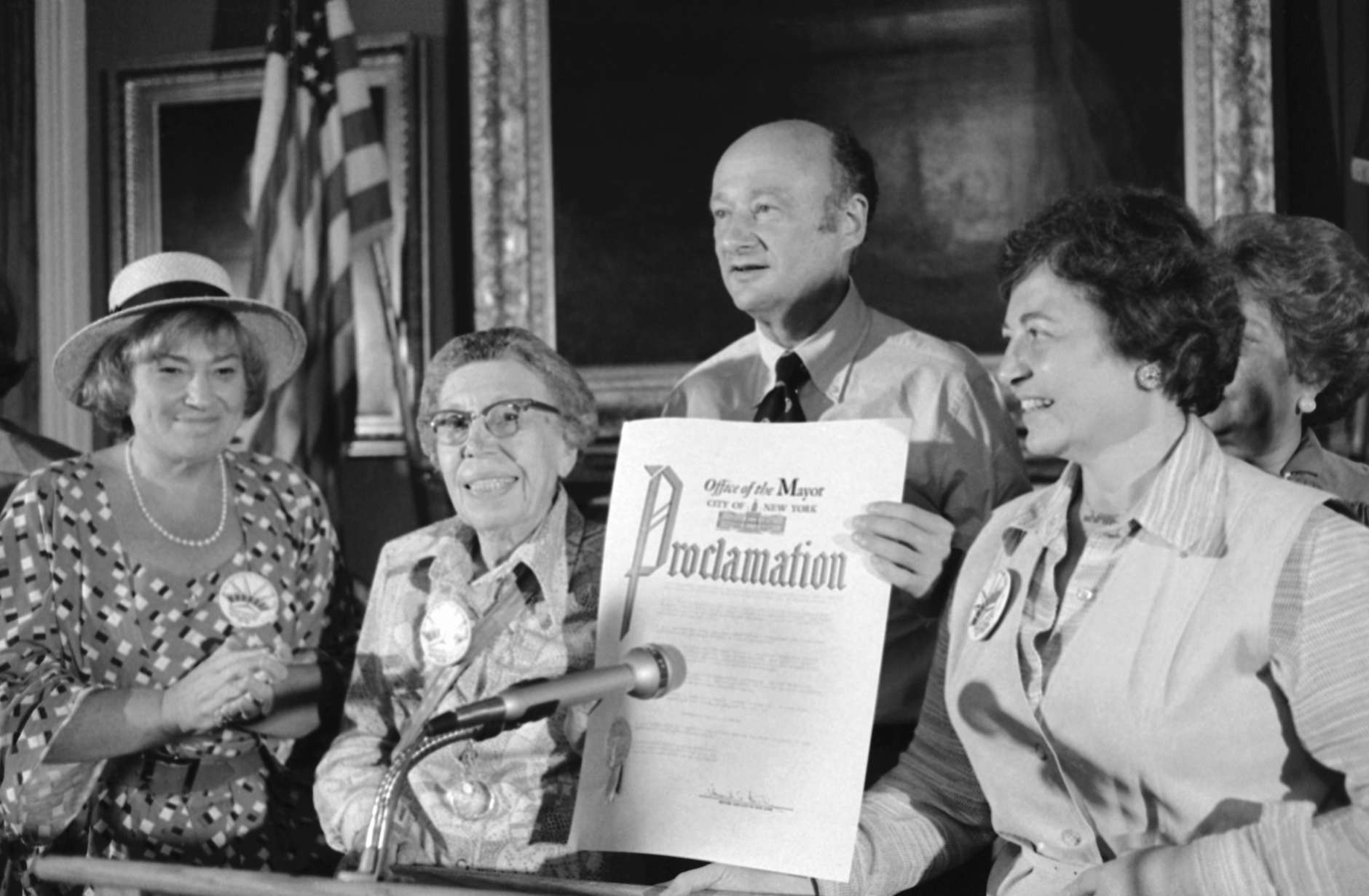 Mayor Ed Koch of New York City holds a proclamation for "Women's Equality Week," at a City Hall ceremony, Monday, August 28, 1978 in New York, as former congresswoman Bella Abzug, left, suffragist Isola Reid Doric, 86; and Lt. Gov. Mary Anne Krupsak, right, look on. Doric joined the suffrage movement in 1913 and accepted the proclamations celebrating the 58th anniversary of suffrage. (AP Photo/Pickoff)