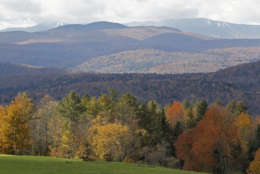Snow on ski trails at the Sugarbush ski area are seen on mountaintops with fall colors on the hillside on Monday, Oct. 8, 2012 in East Montpelier, Vt. The annual foliage display in Vermont is reaching its peak.(AP Photo/Toby Talbot)