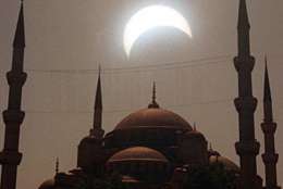 The solar eclipse is seen between the minarets of the historical Blue Mosque in Istanbul, Turkey on Wednesday August 11, 1999. This is the last solar eclipse of this millenium, which swept accross Europe towards the Bay of Bengal. (AP Photo/Erhan Sevenler/Anatolia)