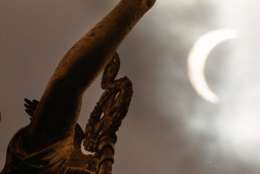 Berlin's Goddess of Victory stands in front of the solar eclipse on Wednesday, August 11, 1999 in Berlin, Germany. The solar eclipse only reached 87 percent in Berlin. (AP Photo/Markus Schreiber)