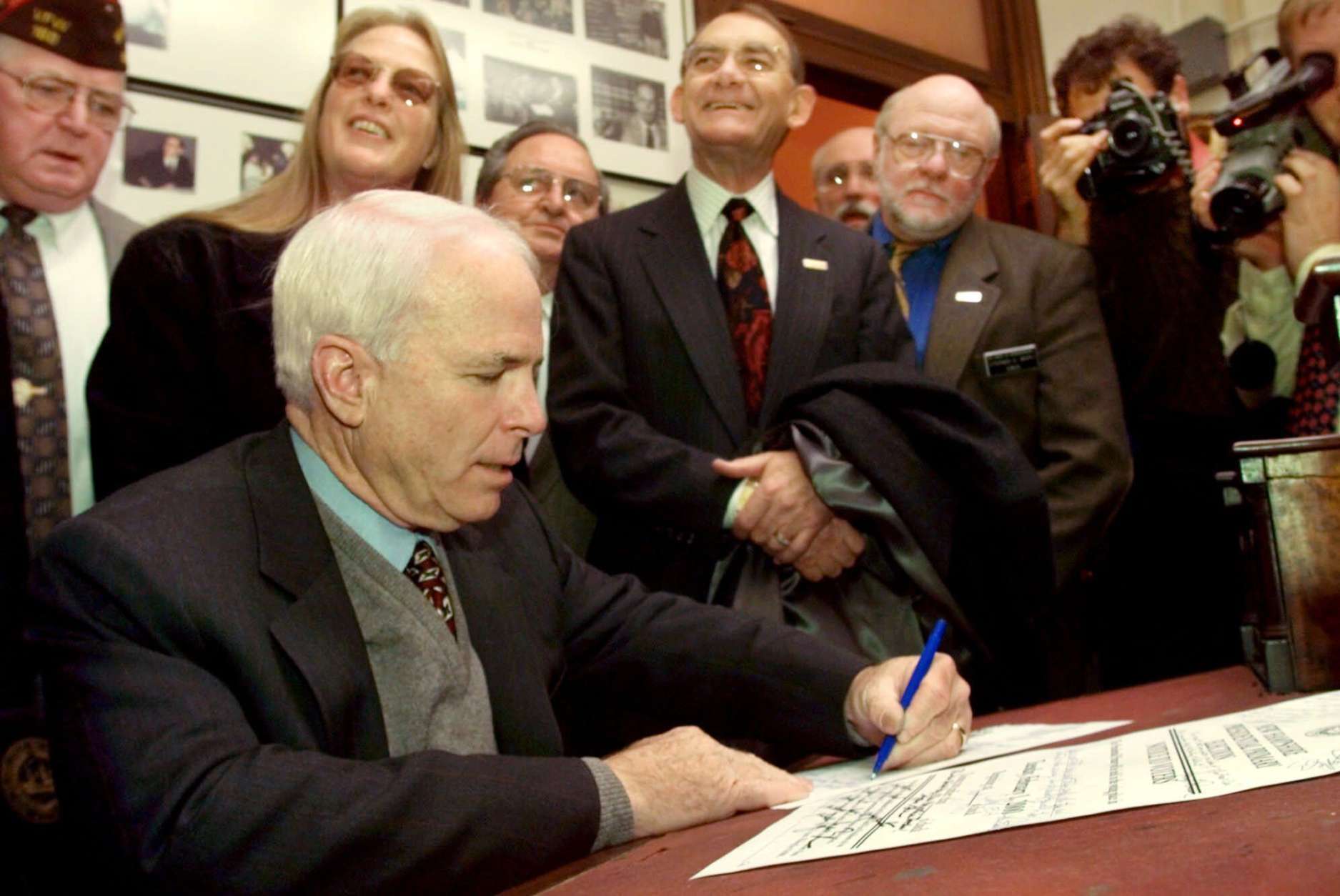 ** FILE ** In this Nov. 12, 1999 file photo, Republican presidential hopeful. Sen. John McCain, R-Ariz. signs his papers at the Secretary of  State's office in Concord, N.H., to get his name on the presidential primary ballot. McCain still has his supporters in New Hampshire, a state where voters arguably know him as well if not better than his constituents back home in Arizona.  (AP Photo/Jim Cole, File)