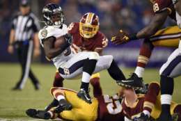 Baltimore Ravens running back Taquan Mizzell (33) is tackled in the second half of a preseason NFL football game against the Washington Redskins, Thursday, Aug. 10, 2017, in Baltimore. (AP Photo/Nick Wass)