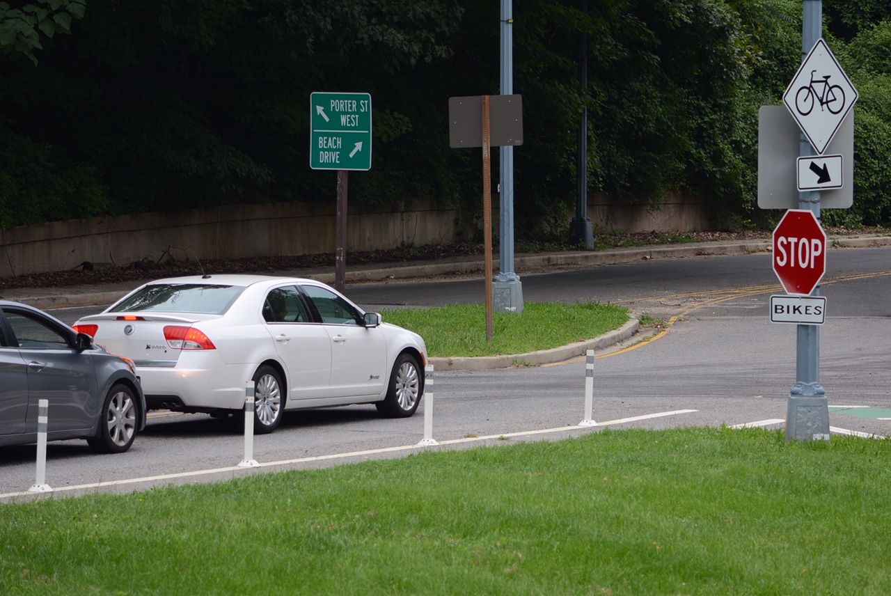 At first glance this stop sign on the ramp from Porter Street to Beach Drive seems harmless but is it for drivers or cyclists? About one in three drivers hits the brakes abruptly when they approach this sign. (WTOP/Dave Dildine)