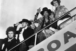 1968:  Jimi Hendrix and Mitch Mitchell of The Jimi Hendrix Experience wave goodbye as they board an aeroplane at London Airport, with assorted members of the Byrds, the Soft Machine and the Alan Price Set.  (Photo by J. Wilds/Keystone/Getty Images)