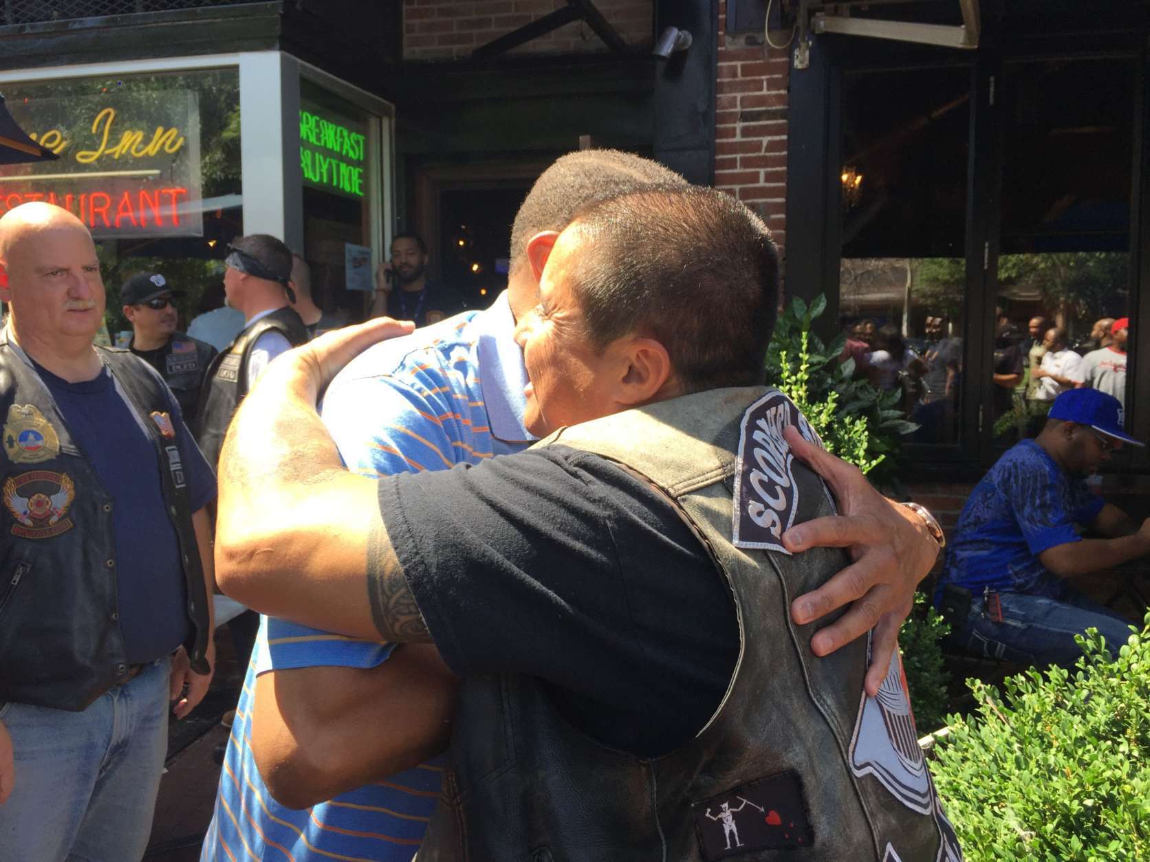 "These people are here every day protecting the citizens of this city," said Former D.C. Fire Chief Donald Edwards (left). He's shown here hugging Robert Alvarado, president of the Scorched Souls Motorcycle Club, which is made up of D.C. firefighters. They were among the first responders and others gathered at Tune Inn on Capitol Hill Wednesday for a fundraiser to help the family of Firefighter Dane Smothers Jr. Smothers was critically injured Aug. 3 preparing to battle a blaze in Northeast. (WTOP/Kristi King)