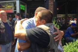 "These people are here every day protecting the citizens of this city," said Former D.C. Fire Chief Donald Edwards (left). He's shown here hugging Robert Alvarado, president of the Scorched Souls Motorcycle Club, which is made up of D.C. firefighters. They were among the first responders and others gathered at Tune Inn on Capitol Hill Wednesday for a fundraiser to help the family of Firefighter Dane Smothers Jr. Smothers was critically injured Aug. 3 preparing to battle a blaze in Northeast. (WTOP/Kristi King)