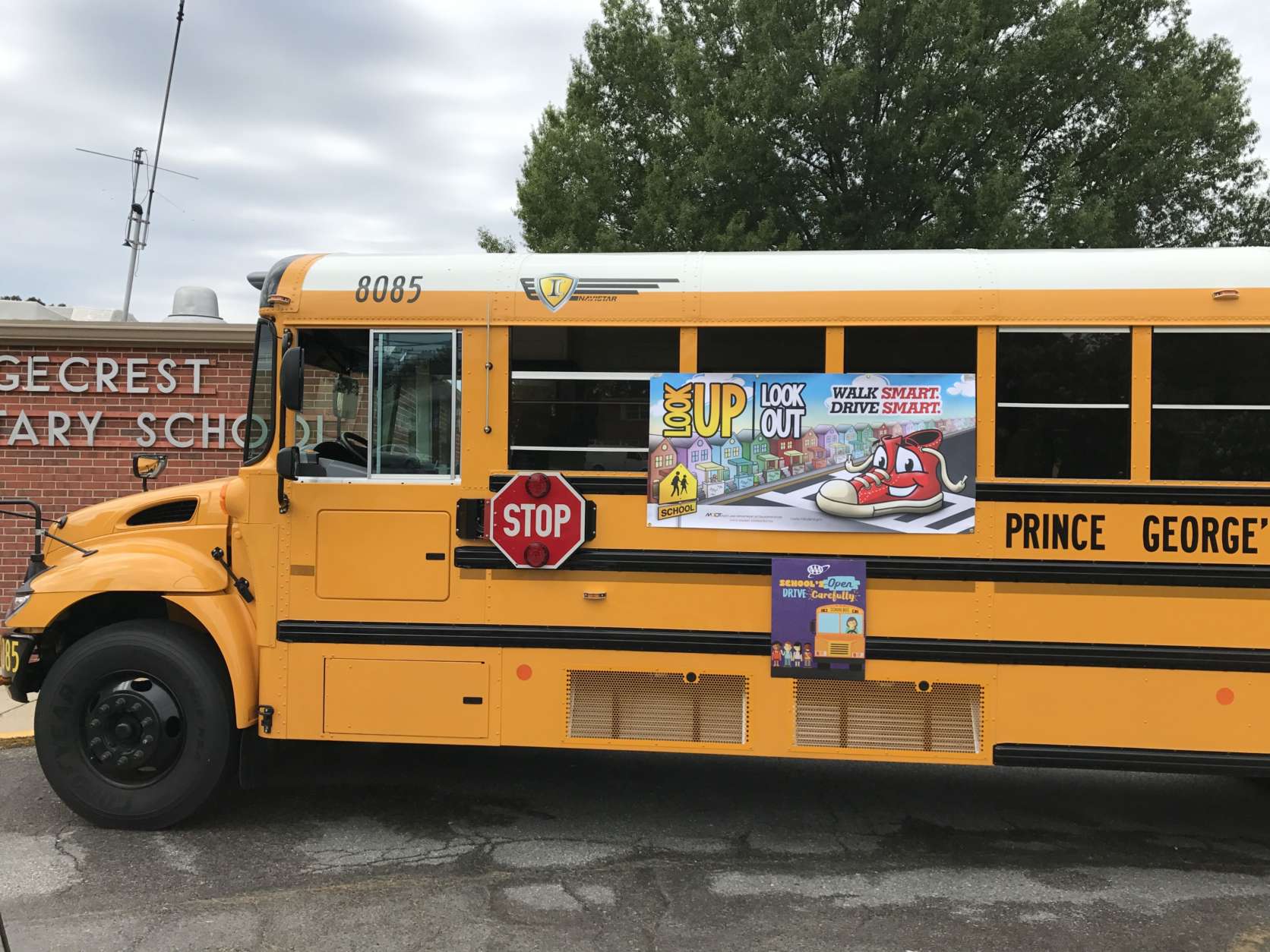 Drivers in both directions are required to stop when a school bus stops, its red lights are flashing and its stop sign flap is deployed. (WTOP/Dick Uliano)