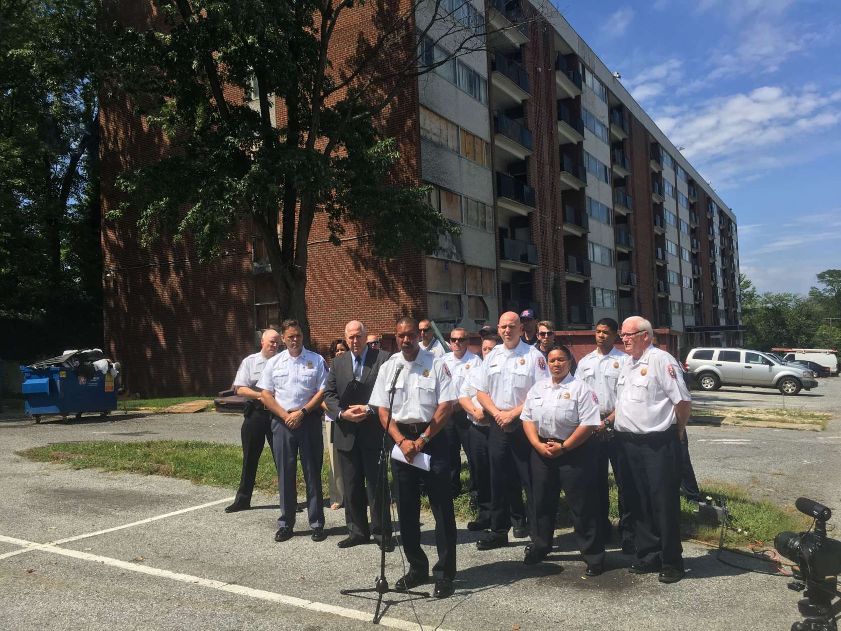 Prince George's County Fire Chief Benjamin Barksadale and other fire officials outside the Lynnhill condominium complex, in Temple Hills on Aug. 18, (WTOP/Mike Murillo)