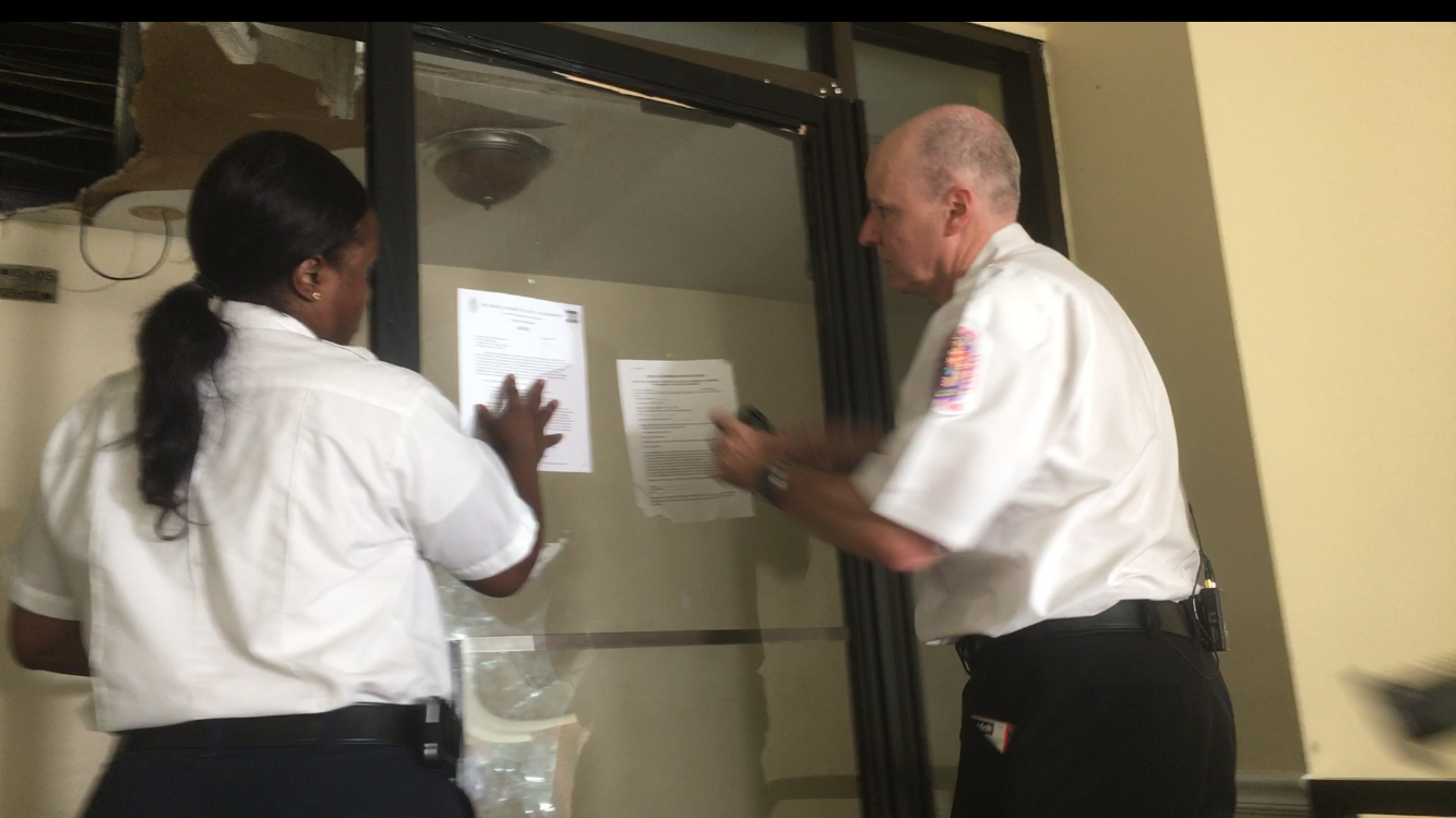 Fire officials post a warning at the Lynnhill condominium complex. (WTOP/Mike Murillo)
