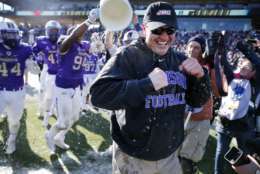 James Madison head coach Mike Houston smiles after being dunked by his team following their 28-14 win against Youngstown State in the FCS championship NCAA college football game, Saturday, Jan. 7, 2017, in Frisco, Texas. (AP Photo/Tony Gutierrez)