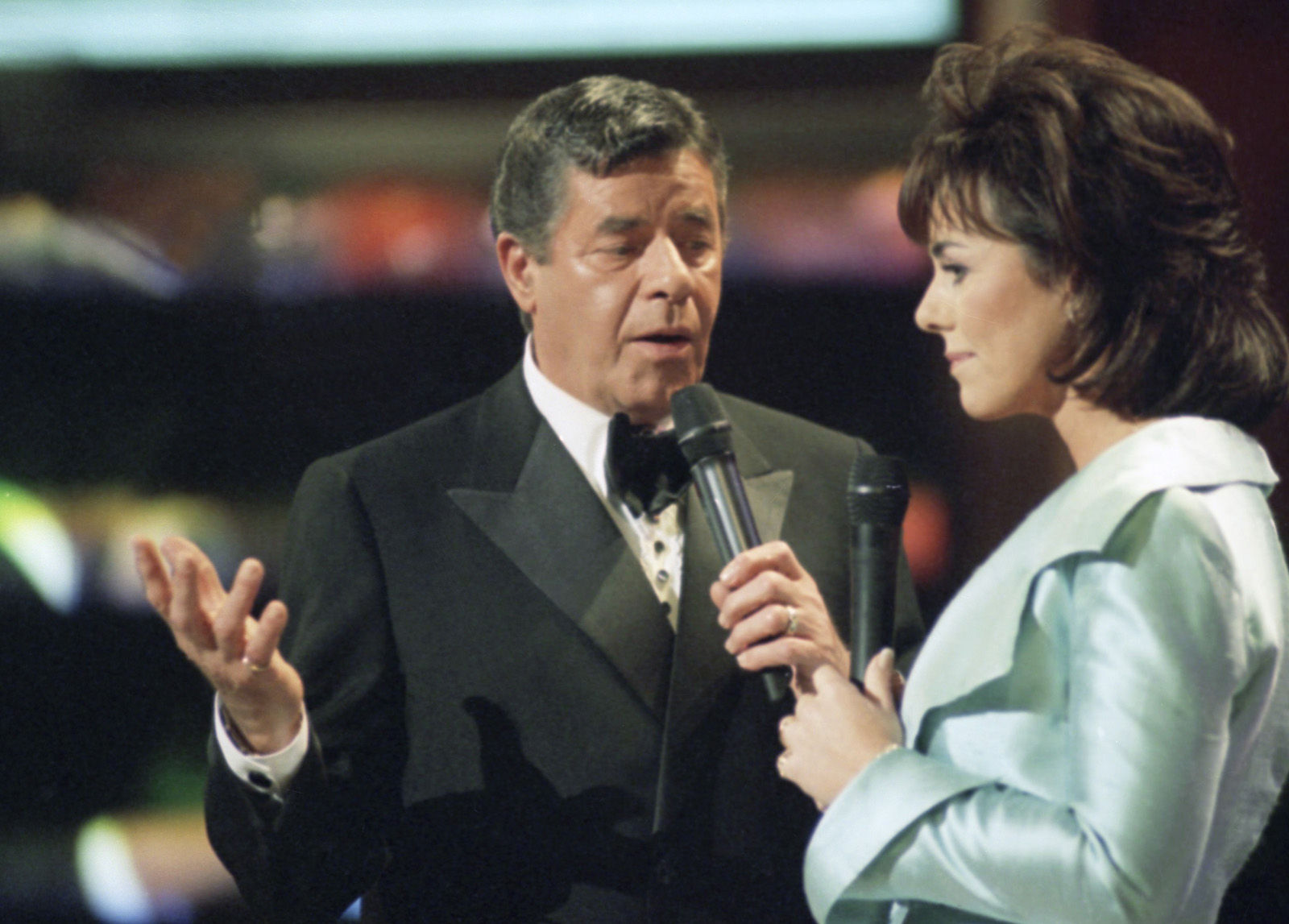 Jerry Lewis, left, is joined by Kathleen Sullivan as a co-host of the Jerry Lewis Stars Across America, MDA Labor Day Telethon, Sunday, Sept. 3, 1995, Los Angeles, Calif. Lewis hopes the more than 21 hour telecast will exceed the 1994 pledge of $47.1 million. (AP Photo/Michael Tweed)