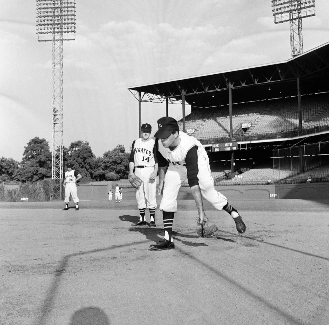 Comedian Jerry Lewis works out at first base prior to Pittsburgh-Houston ballgame at Forbes Field on July 13, 1962 in Pittsburgh.    Watching his antics is Pittsburgh's first baseman Jim Marshall. (AP Photo)