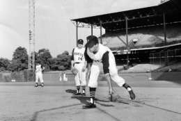 Comedian Jerry Lewis works out at first base prior to Pittsburgh-Houston ballgame at Forbes Field on July 13, 1962 in Pittsburgh.    Watching his antics is Pittsburgh's first baseman Jim Marshall. (AP Photo)