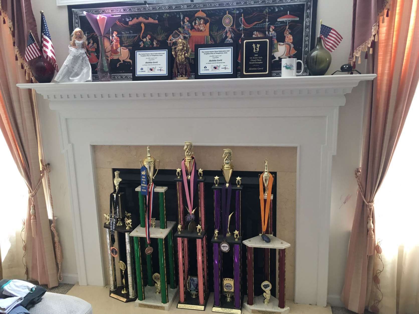 A host of awards line the fireplace at Gorti's home from the tournaments she's won. (WTOP/Noah Frank)