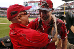 Washington Nationals owner Mark Lerner, left, embraces Washington Nationals starting pitcher Max Scherzer, who is covered with chocolate syrup, after Scherzer's no-hitter baseball game against the Pittsburgh Pirates at Nationals Park, Saturday, June 20, 2015, in Washington. The Nationals won 6-0. (AP Photo/Alex Brandon)
