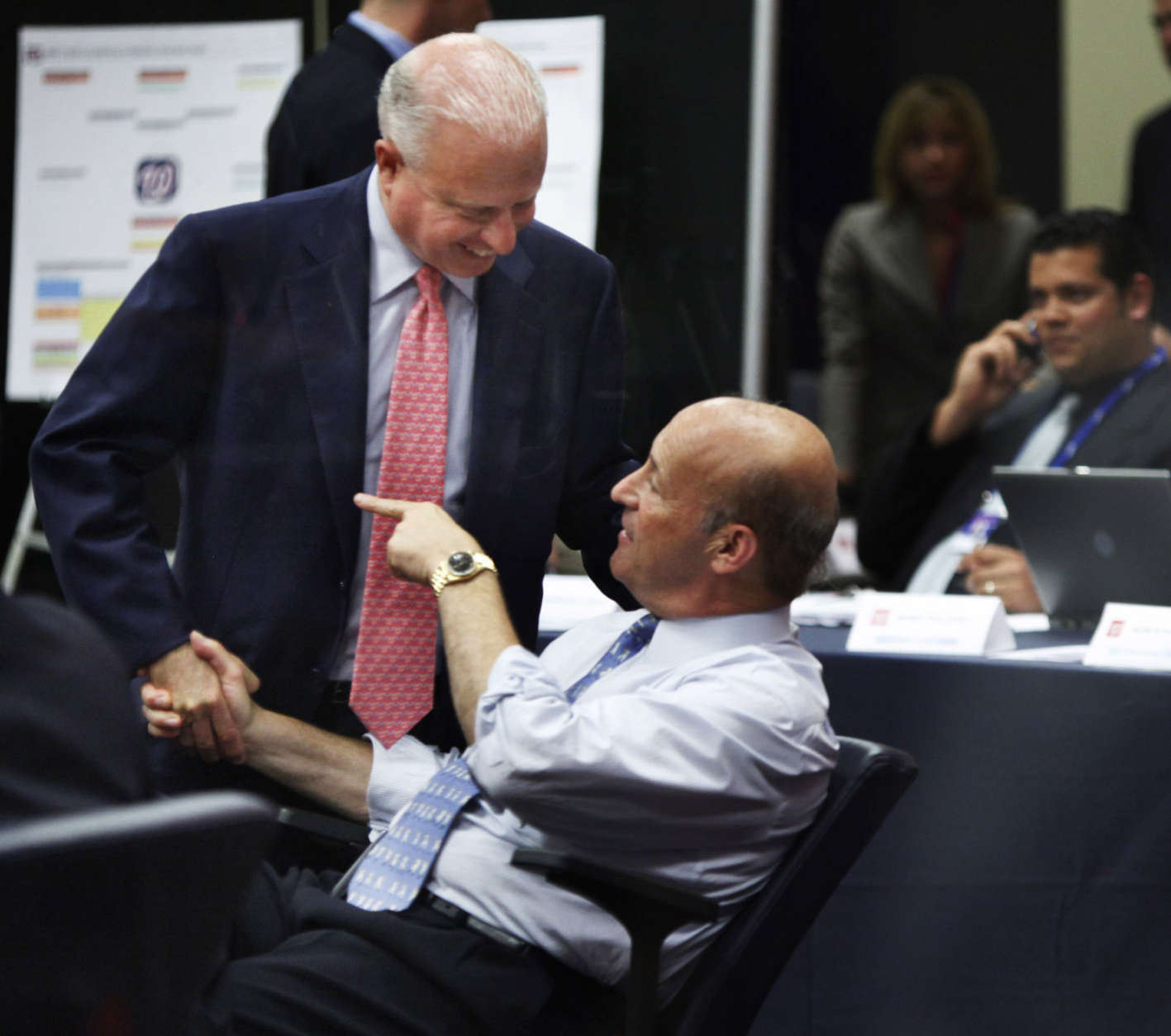 Washington Nationals owner Mark Lerner, left, shakes hands with the baseball team's president, Stan Kasten, right, after the Nationals selected pitcher Stephen Strasburg with the first pick in the baseball draft, at Nationals Park in Washington, Tuesday, June 9, 2009. (AP Photo/Manuel Balce Ceneta)
