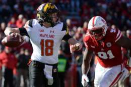LINCOLN, NE - NOVEMBER 19: Quarterback Max Bortenschlager #18 of the Maryland Terrapins passes ahead of the rush from defensive lineman Adam McLean #91 of the Maryland Terrapins at Memorial Stadium on November 19, 2016 in Lincoln, Nebraska. Nebraska defeated Maryland 28-7.  (Photo by Steven Branscombe/Getty Images)