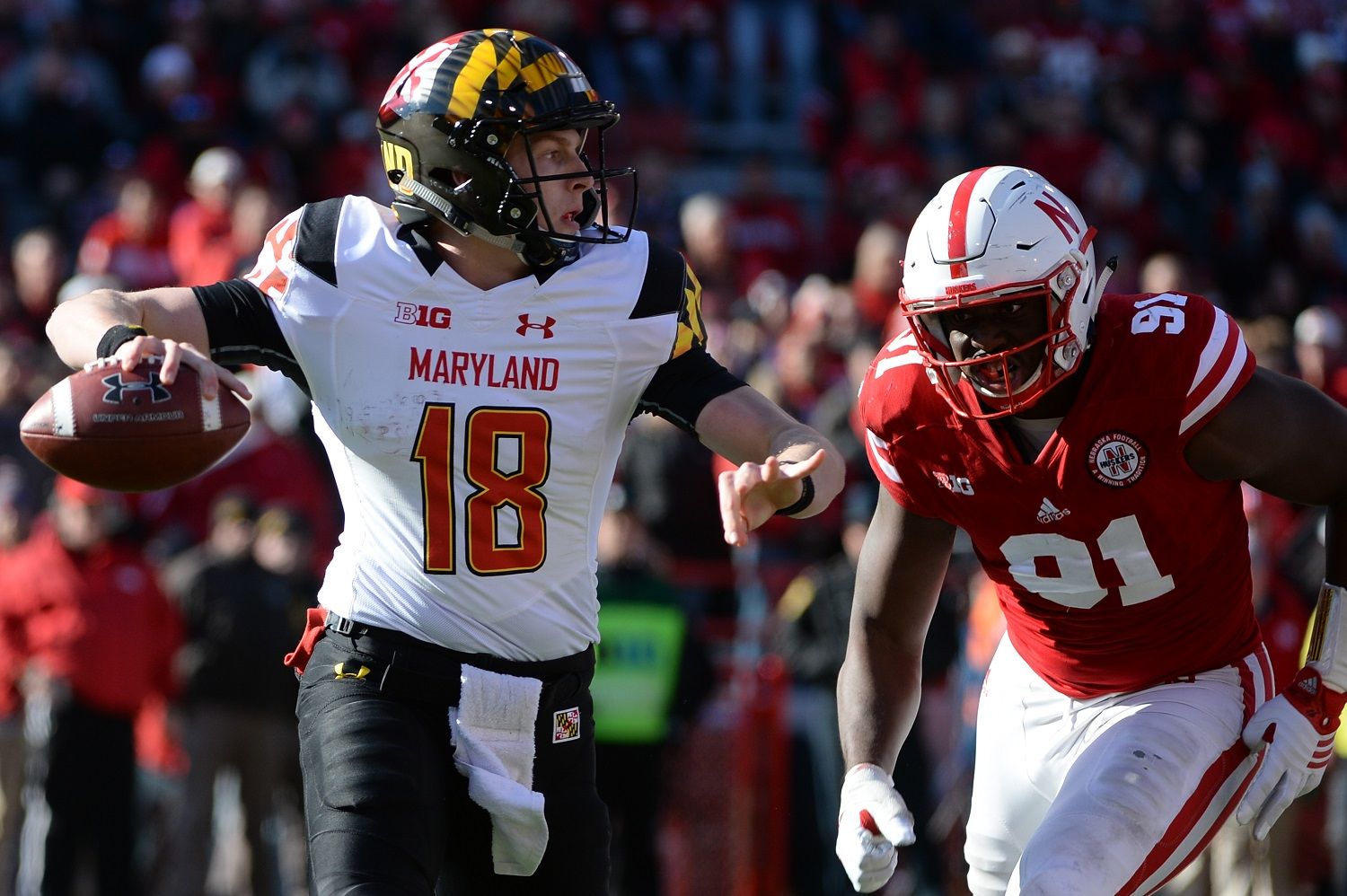LINCOLN, NE - NOVEMBER 19: Quarterback Max Bortenschlager #18 of the Maryland Terrapins passes ahead of the rush from defensive lineman Adam McLean #91 of the Maryland Terrapins at Memorial Stadium on November 19, 2016 in Lincoln, Nebraska. Nebraska defeated Maryland 28-7.  (Photo by Steven Branscombe/Getty Images)