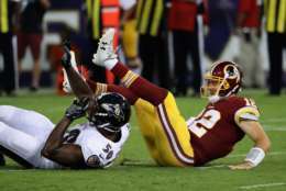 BALTIMORE, MD - AUGUST 10: Quarterback Colt McCoy #12 of the Washington Redskins is hit by outside linebacker Albert McClellan #50 of the Baltimore Ravens after throwing a first half pass during a preseason game at M&amp;T Bank Stadium on August 10, 2017 in Baltimore, Maryland.  (Photo by Rob Carr/Getty Images)