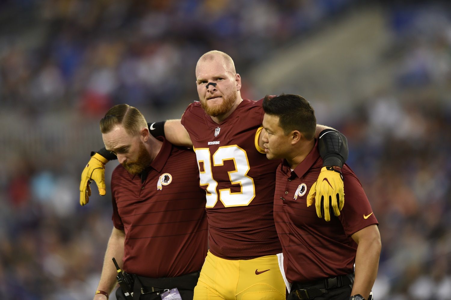 Washington Redskins linebacker Trent Murphy (93) is assisted off the field in the first half of a preseason NFL football game against the Baltimore Ravens, Thursday, Aug. 10, 2017, in Baltimore. (AP Photo/Gail Burton)