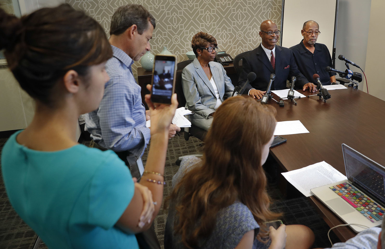 Attorney Ted Williams, right center, for Barbara, center, and Phillip Butler, right, victims of a cross burning on their property forty years ago, speaks during a news conference at Williams office in Washington, Wednesday, Aug. 23, 2017. Forty years ago, Catholic Priest William Aitcheson, was a Ku Klux Klan "wizard", has come forward after decades as a Catholic priest, he's coming forward about his past. (AP Photo/Pablo Martinez Monsivais)