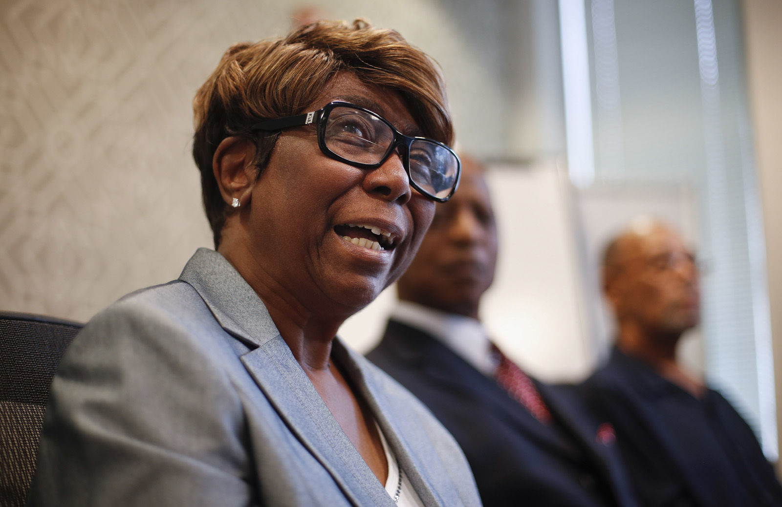 Barbara Butler, accompanied by her husband Phillip, speaks during a news conference at their attorney's office in Washington, Wednesday, Aug. 23, 2017. The Butlers, victims of a cross burning on their property forty years ago, is questioning the sincerity of Catholic Priest William Aitcheson, a Ku Klux Klan "wizard", who has come forward after decades about his past. (AP Photo/Pablo Martinez Monsivais)