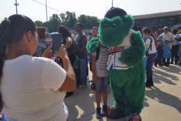 Louie, the mascot for the Bowie Baysox, poses with a fan at the Back-to-School Fair at Prince George's Stadium. (WTOP/Kathy Stewart)