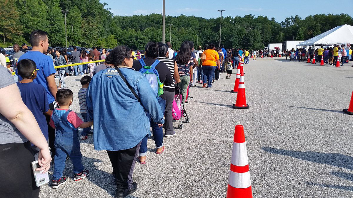 Families in line for Prince George's County Public Schools "Back-to-School Fair" at Bowie Baysox Stadium. (WTOP/Kathy Stewart)
