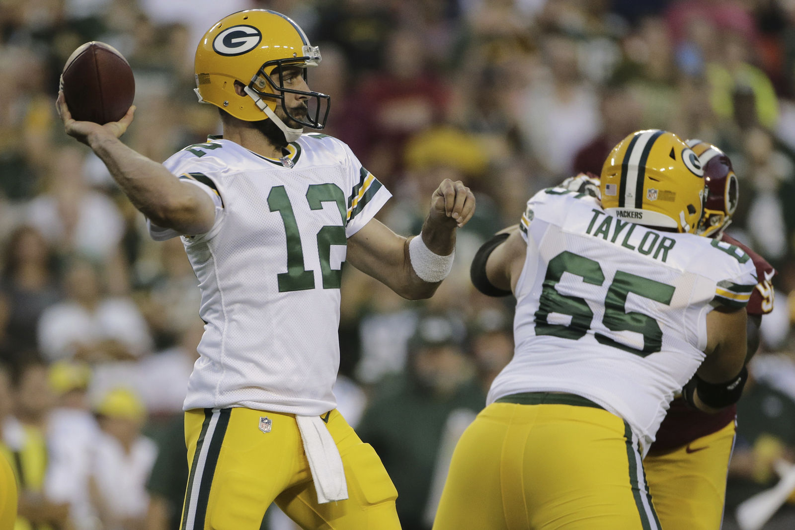 Green Bay Packers quarterback Aaron Rodgers (12) passes the ball during the first half of an NFL preseason football game against the Washington Redskins in Landover, Md., Saturday, Aug. 19, 2017. (AP Photo/Mark Tenally)