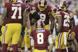 Washington Redskins quarterback Kirk Cousins (8) leads a team huddle during the first half of an NFL preseason football game against the Green Bay Packers in Landover, Md., Saturday, Aug. 19, 2017. (AP Photo/Mark Tenally)