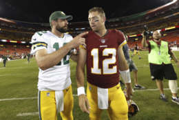 Green Bay Packers quarterback Aaron Rodgers (12) and Washington Redskins quarterback Colt McCoy (12) talk as they walk off the field after an NFL preseason football game in Landover, Md., Saturday, Aug. 19, 2017. The Packers defeated the Redskins 21-17. (AP Photo/Alex Brandon)