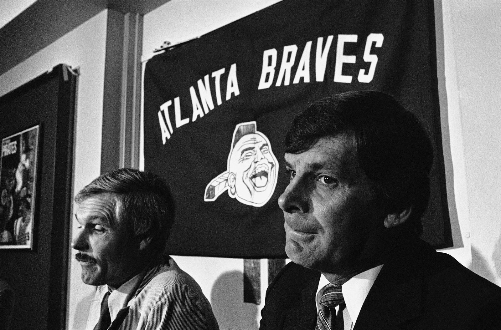 In 2013, the Braves considered bringing back their logo they retired after 1989, seen in the background here in this 1981 photo, on spring training hats however outrage prompted them to change the logo.

FILE. Bobby Cox (right) listens as Atlanta Brave Owner Ted Turner (left) announces at a news conference on Thursday, Oct. 8, 1981 in Atlanta that Cox would not be manager of the ball club next season. Cox has been with th Braves since 1978.   No replacement was named. (AP Photo/ Joe Holloway)