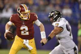 Washington Redskins quarterback Nate Sudfeld, left, tries to outrun Baltimore Ravens defensive end Bronson Kaufusi in the second half of a preseason NFL football game, Thursday, Aug. 10, 2017, in Baltimore. (AP Photo/Nick Wass)