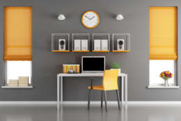 Gray and orange modern workspace with little desk with laptop and two windows - 3d rendering