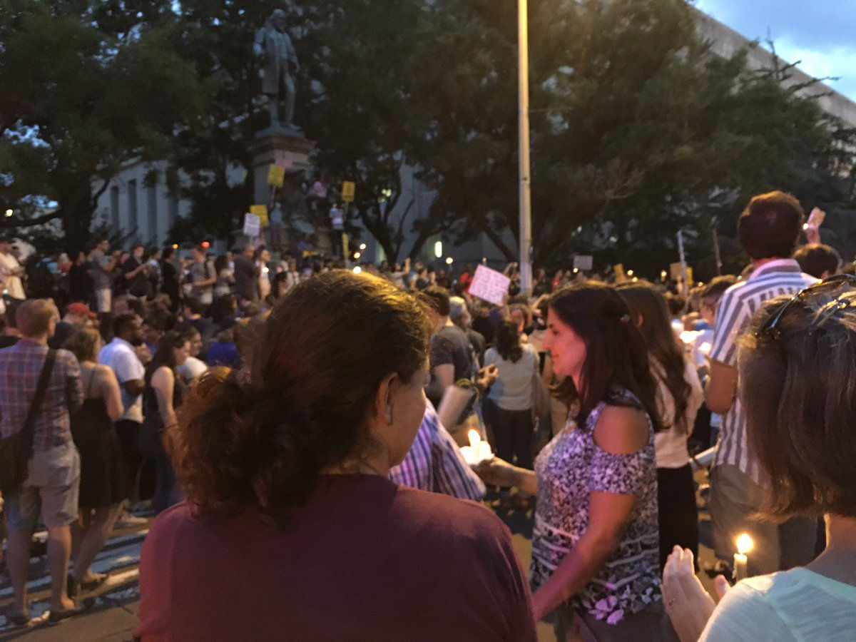 Protesters in front of the statue of Albert Pike in D.C. lit candles for those hurt and killed during the violence in Charlottesville, Virginia on Aug. 12. (WTOP/Liz Anderson)